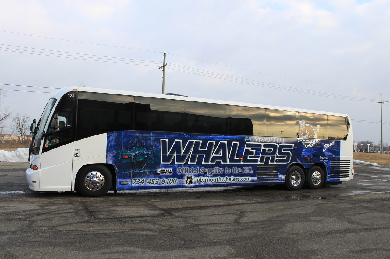 A Plymouth Whalers team bus parked in an empty lot